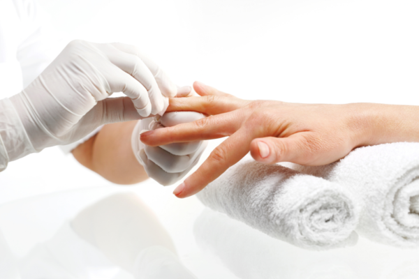 Una persona recibiendo un tratamiento de manicura